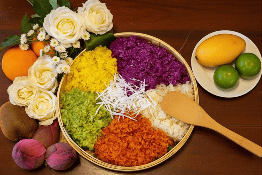 A bamboo tray of colorful sticky rice arranged like a rainbow, usually served with sesame salt